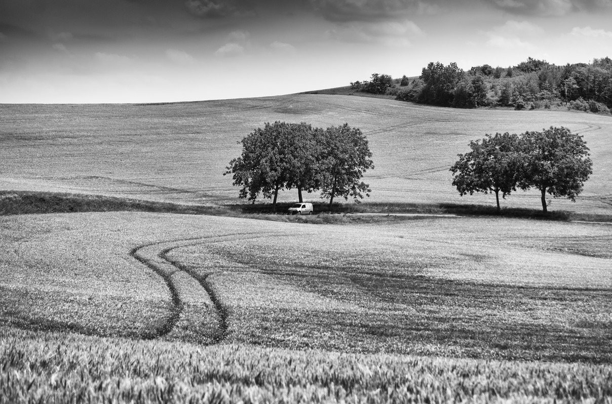 Small white van in a French rural landscape